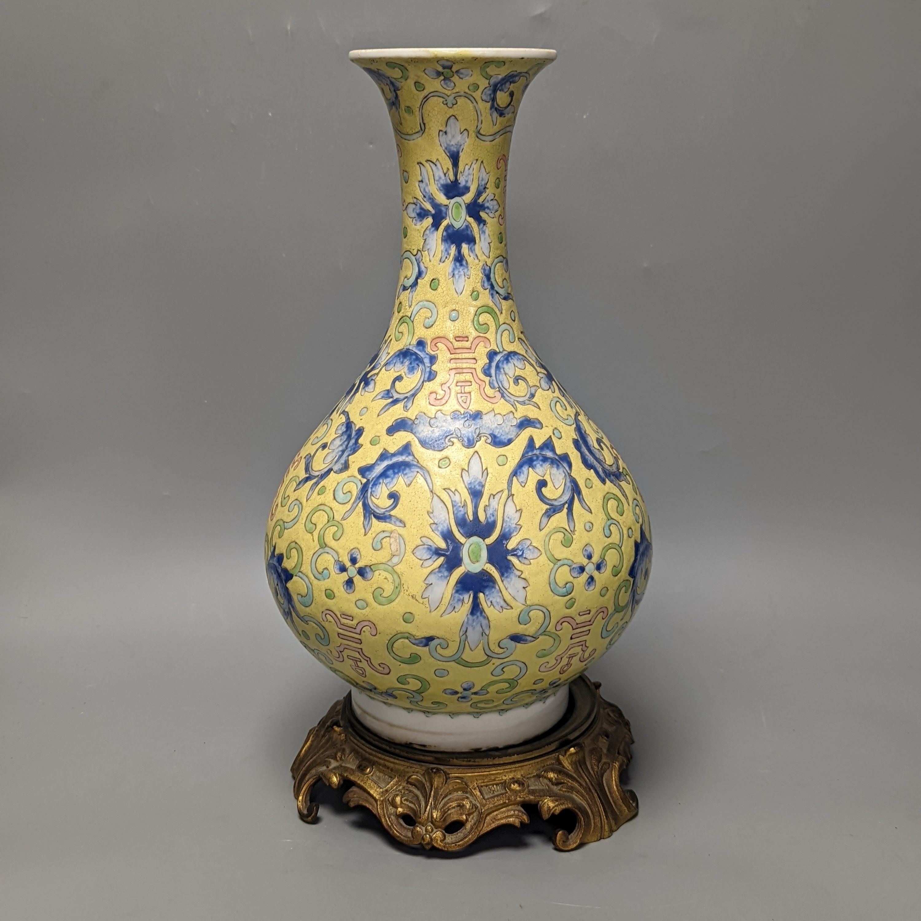 A Chinese yellow ground vase, raised on a gilt bronze base 38cm